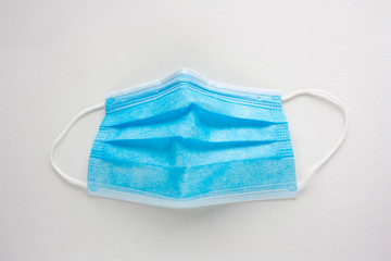 Surgical mask with rubber ear straps. Typical 3-ply surgical mask to cover the mouth and nose. Procedure mask from virus.