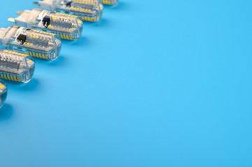 Several LED bulb on blue background. Saving energy concept. Ftat lay, top view, copy space. Bulbs...