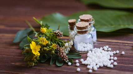 Bottles of homeopathic globules. Homeopathic medicine, jars with homeopathic sugar granules. Naturopathy, aromatherapy, homeopathy - concept