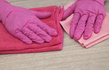 Comparison of two different microfiber cloths. Rubber pink gloves for cleaning.