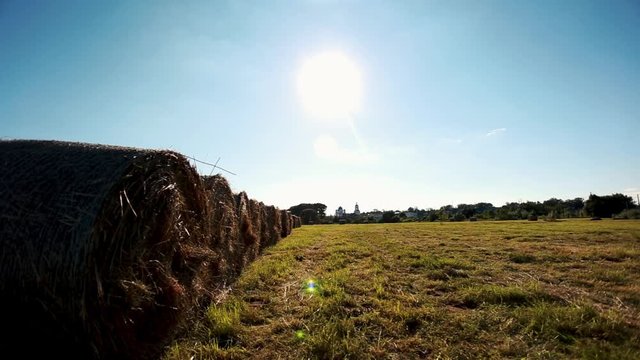 Haystack agriculture field landscape.Agricultural machinery cultivates fields.