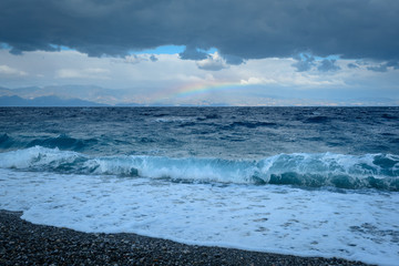 sea, clouds and rainbow