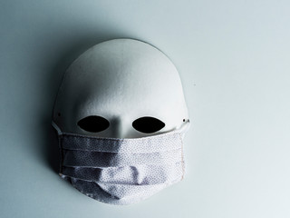 Carnival mask with a medical mask on white background