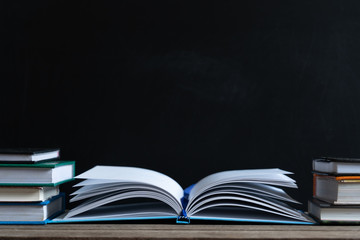 Books and textbook on wooden desk in library selective focus , Piles of books on reading desk in school with copy space for text.World book day and education concept.