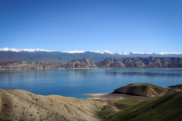 Toktogul Reservoir and Tian Shan mountains view by spring, Kyrgyzia