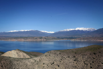 Toktogul Reservoir and Tian Shan mountains view by spring, Kyrgyzia