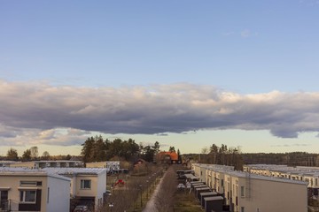 Beautiful landscape view over light yellow townhouses on gorgeous blue sky with white clouds background .Beautiful cityscape background. Europe. Sweden. Uppsala. 