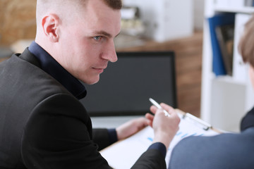 Group of people deliberate on problem with clipboard pad closeup. White collar check money papers, stock exchange market, earnings list, partnership agreement idea discussion, startup concept