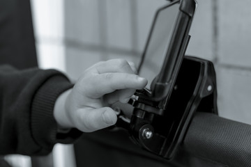 The child uses a smartphone. The boy taps on the tablet screen