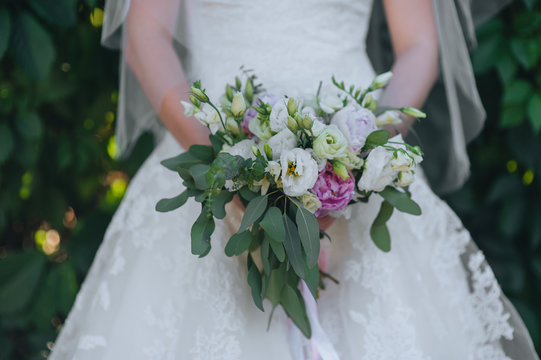 The bride holds a wedding bouquet close-up of roses and peonies. Photography, concept.