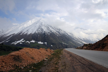 Too Ashuu mountain pass scenic view by spring with white peaks, Kyrgyzia