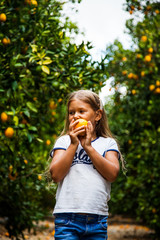 Young girl having fun in orange garden in Cyprus