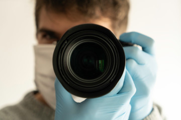 Photographer journalist shooting people street with a mask  and gloves in a quarantine period because of pandemic global danger.