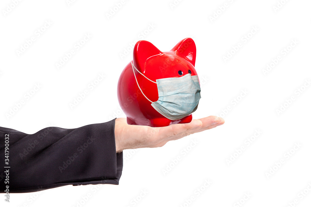 Poster hand holds a red pig piggy bank in a protective mask isolated on white background