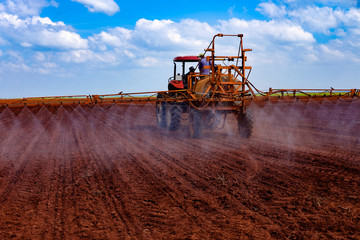 Fototapeta premium Tractor spraying the lands for weeds