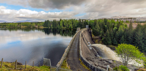 Obraz premium Water release at hydro dam in scottish highlands