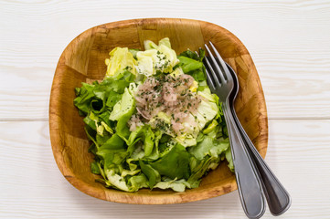fresh green lettuce salad in a bowl isolated
