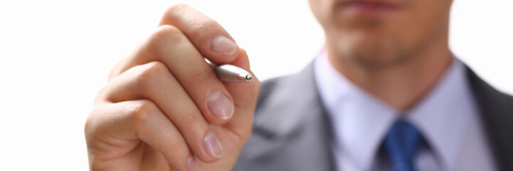 Male arm in suit and tie point in camera tip of silver pen closeup. Sign gesture, read pact, sale agent, bank job, make note, loan credit mortgage investment, finance chief, legal law concept