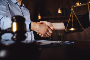 Handshake after good cooperation, Consultation between a male lawyer and businessman customer, tax and the company of real estate concept.