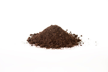 View of a pile of brown soil located on a white background