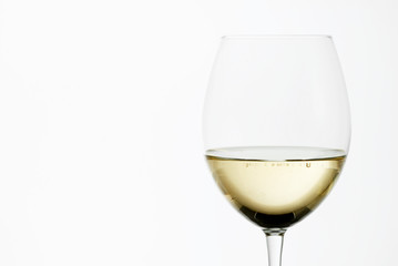 A close up of a white wine glass.