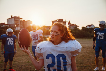 American football woman player in action on the stadium.