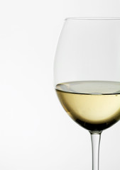 A close up of a white wine glass.