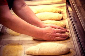 Making bread by bakers at the factory. Bread dough