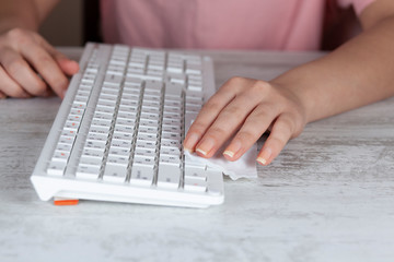 Woman cleaning pc keyboard