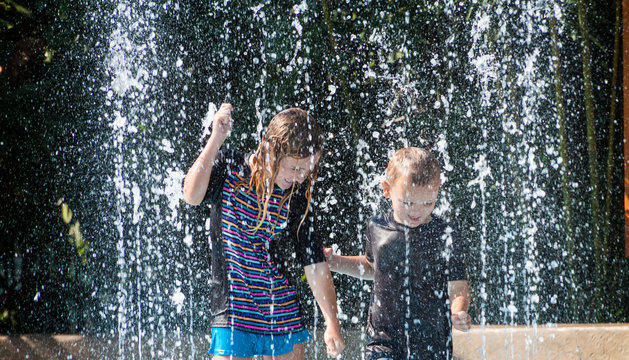 Young Boy and Girl Dancing at Splash Pad, Houston, Texas , USA