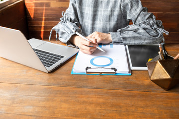 Business woman working at home with her laptoBusiness woman working at home with her laptop and...