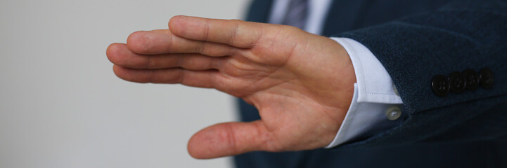 Gesture male hand rejection says no male businessman in a suit on a gray background I will not categorically claim