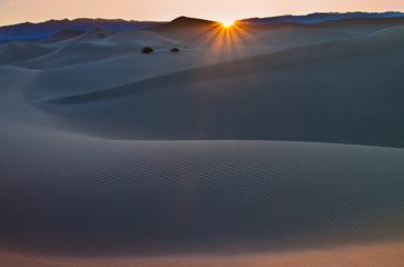 Fototapeta na wymiar Sunrise Over The Mesquite Flat Sand Dunes at the Foot of the Armagosa Mountain Range, Death Valley National Park, California, USA