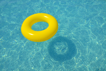 Colorful inflatable tube floating in swimming pool