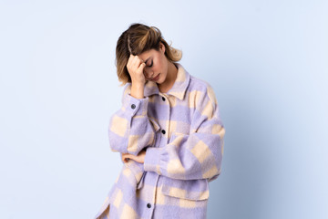 Young Russian woman isolated on blue background with headache
