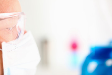 Portrait of a surgeon before the operation in a mask and goggles profile is concentrated and ready to express pride and dignity