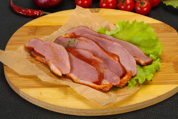 Sliced smoked duck breast served salad