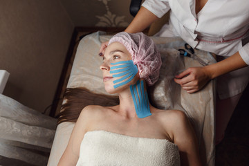 kinesiology tape placed on the shoulder and neck of a model