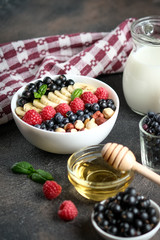 Oatmeal with berries and fruits on a light background. Healthy breakfast.