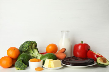 Different natural food rich in vitamin A on white table