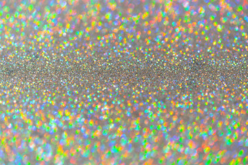 Abstract shiny colored sparkles background with blur bokeh.