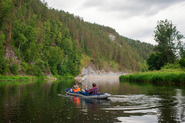 Fototapeta na wymiar Canoeing on a mountain river on a rainy passport day
