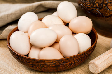 Chicken eggs in a clay bowl. Farm products.