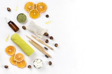 Fototapeta na wymiar self-care kit for body and face. soap nuts, dry orange, coconut oil, spirulina powder, bamboo brushes, towel. DIY eco cosmetics. concept zero waste, no plastic, sustainable. copy space. flat lay