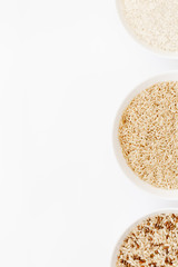 Bowls with different types of raw uncooked rice: brown, red, white, glutinous. The most popular asian healthy food, top view