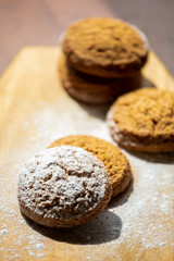 oatmeal cookies on a wooden board sprinkled with powdered sugar