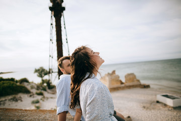 Man and woman relaxing on summer beach. Recreation and love concept