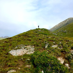 Fototapeta premium Mountain landscape with a silhouette of a man on top of a mountain. There is a place for inscription.