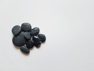 Black pebbles on white isolated 