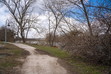 Hiking trail on the riverside during cloudy weather 